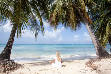 women maditating on the beach in Barbadosの写真素材