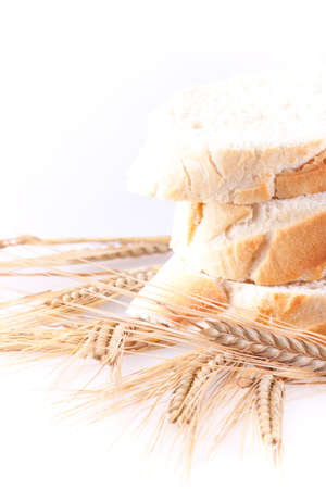 chopped bread and wheat in white backgroundの写真素材