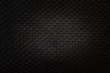 Black basket texture with light on the centerの写真素材