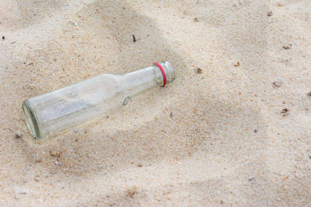 Empty water bottle on the beach の写真素材