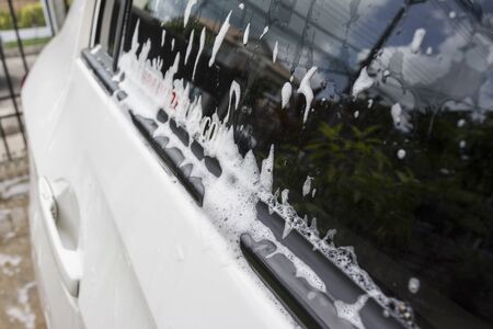 soap bubbles on car window before car washの写真素材