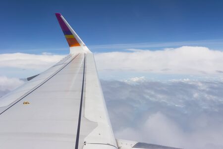 The wings of the plane, and the beautiful view from the glass window of the plane.