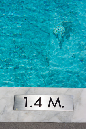 Signs show the depth of the swimming pool.の写真素材