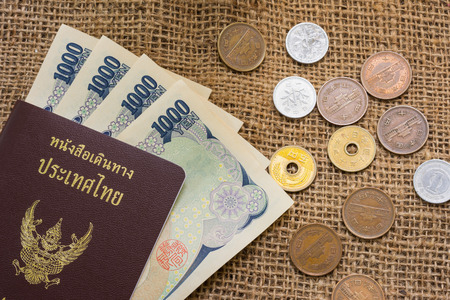 Yen money and yen coin with passport on sack background for travel or business concept.の写真素材