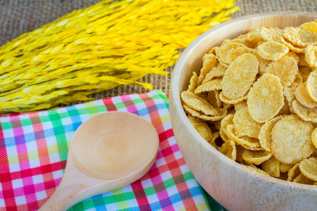 cornflakes and yellow rice with sack or tablecloth background