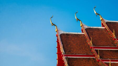 Thai Temple roof with blue sky backgroundの写真素材