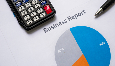 business report or Financial paper with pen and calculator in business concept with sun lightの写真素材