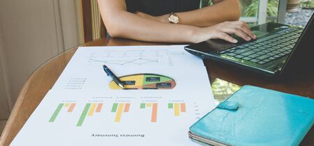 Woman use computer for work with Business summary or Business plan report with Charts and graphs in...