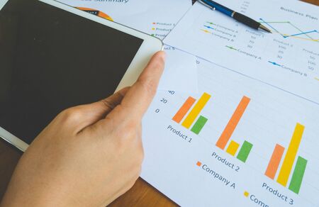 Close-up of Working woman use tablet for work with Business summary or Business plan report with...