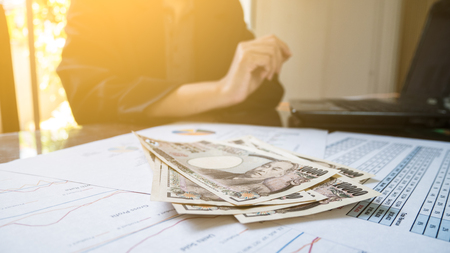 Japan money in hand with Statement paper in financial concept.の写真素材