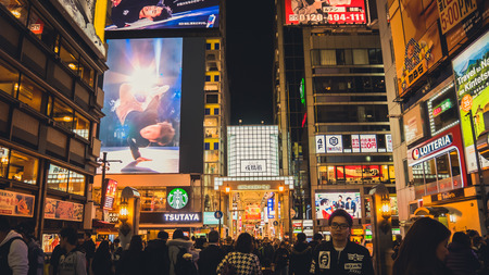 OSAKA APRIL 10 , 2017 : Dotonbori district is a popular shopping area in Osaka Prefecture and has a famous restaurant. The tourists are coming in at night , process in Cinimatic Styleのeditorial素材