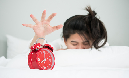 Asian woman tries to turn off the alarm.の写真素材