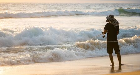 The fisherman fishing on the beach.の写真素材