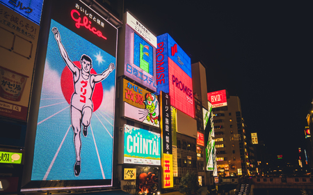 OSAKA APRIL 10 , 2017 : Dotonbori district is a popular shopping area in Osaka Prefecture and has a famous restaurant. The tourists are coming in at night , process in Cinimatic Styleのeditorial素材