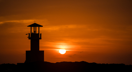 silhouette light house with the susset view.の写真素材