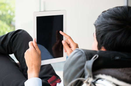 Managers or businessman are using the tablet on the sofa in the weekendの写真素材