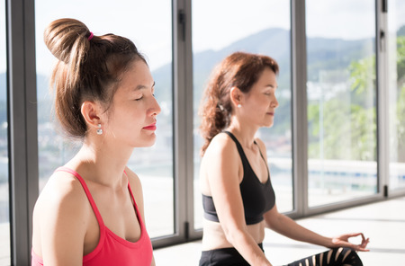 Elderly women are playing yoga relaxation in sukhasana posturer in healthy and yoga conceptの写真素材