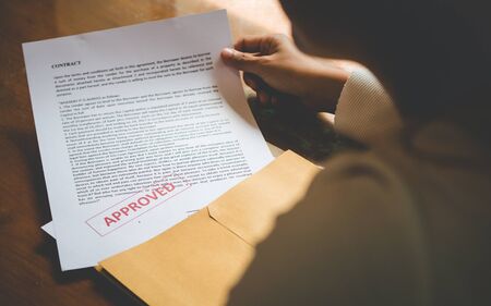 Women are opening an envelope document about signing a contract in business and sign contract concept,vintage style の写真素材