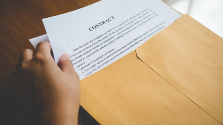 Women are opening an envelope document about signing a contract in business and sign contract concept,vintage styleの写真素材