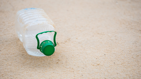 Plastic water bottles on the beach by people made pollution and environmental in conceptの写真素材