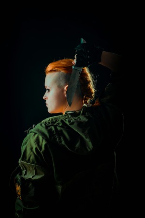 Young woman with red hair in military green uniform
