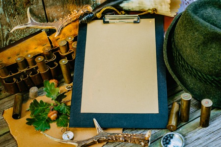 Closeup clipboard with paper for information surround hunting or tourist vintage equipment.の写真素材