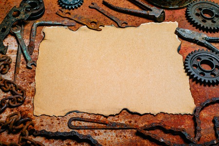 Vintage paper in the center tools on old metal background. Motorcycle tools, equipment and repair.の写真素材