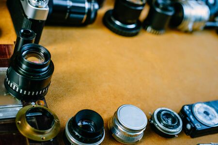 Retro mockup, vintage photographic accessories and quipments around on wooden Background.