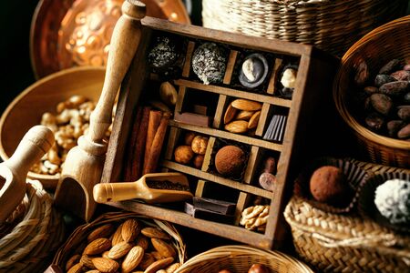 Handmade candies, nuts and spice inside of vintage box which devided on sectionsの写真素材