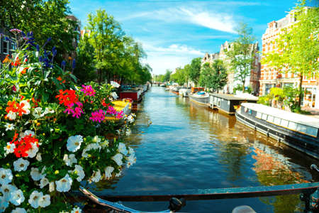 Canal in Amsterdam with boats and beautiful flowers. Summer moring June 2019の写真素材