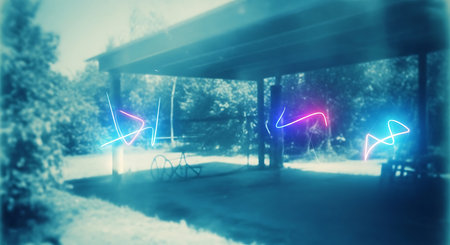 Digital composite of Colorful lights against road with bicycle in the parkの素材
