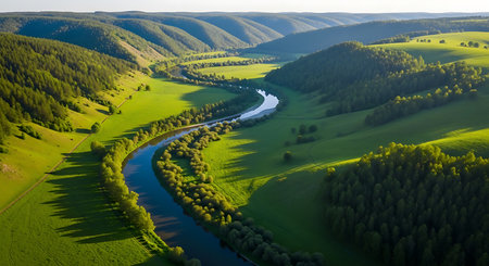 Aerial view of the river flowing through the green hills in springの素材