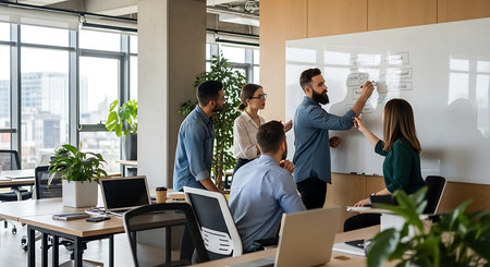 Group of diverse young business people in smart casual wear working and communicating together in modern bright office.の素材