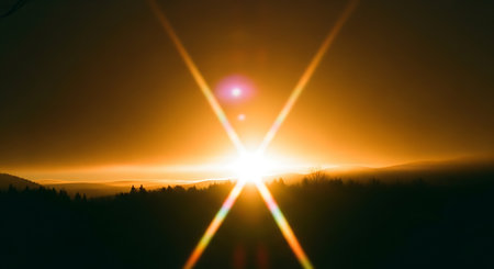 Sunset in the mountains with rays of light and lens flare effectの素材