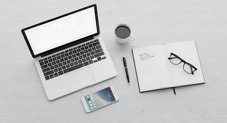 Laptop, notebook, smartphone and coffee cup on white table. 3d rendering.の素材