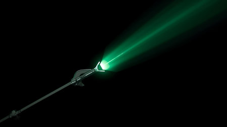 Flashlight on a black background. Close-up of a green laser.の素材