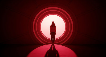 Silhouette of a woman standing in front of a red light tunnel.の素材