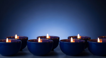 Candles in a row on a dark blue background with copy spaceの素材