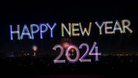 Happy new year 2014 written with colorful firework over cityscape backgroundの素材