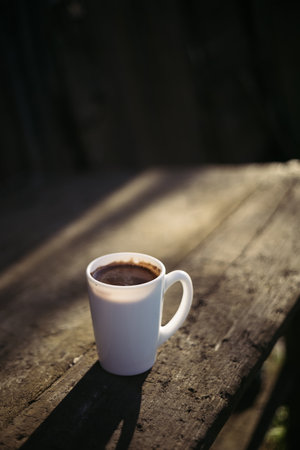 Coffee cup on wooden table in the morning with copy spaceの写真素材