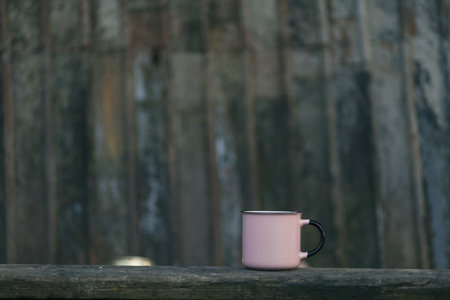 coffee cup on wood background, vintage color tone and selective focus