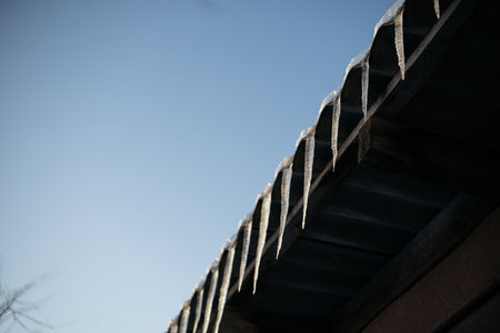 The roof of the building is covered with a thin layer of frost.