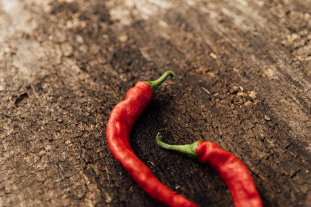 Red hot chili peppers on a wooden background. Selective focus.