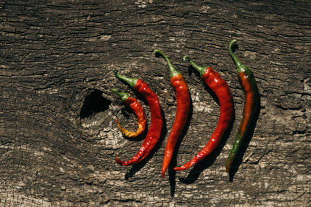 Red hot chili peppers on old wooden background. Top view. Selective focus.の写真素材