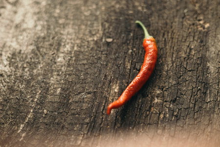 Red hot chili pepper on old wooden background. Copy space for text.の写真素材