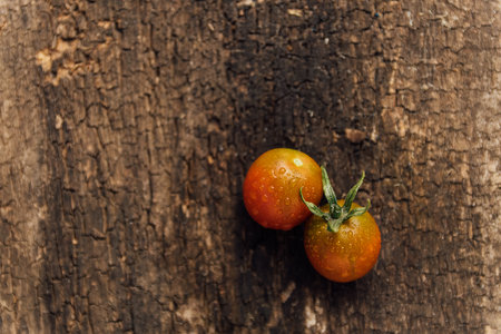Cherry tomatoes on wooden background. Top view. Copy space.の写真素材