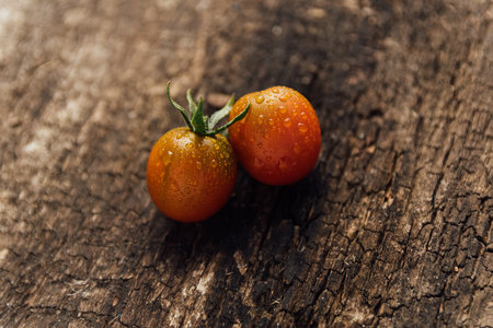 Ripe cherry tomatoes on a wooden background. Selective focus.の写真素材