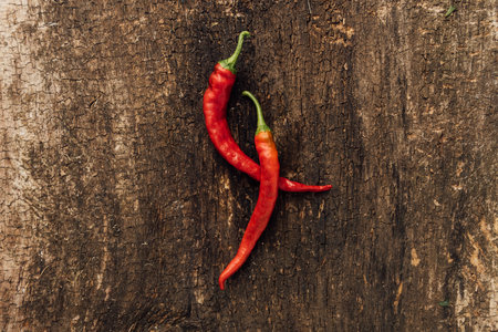 Red hot chili peppers on wooden background, top view, copy spaceの写真素材