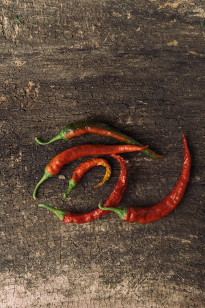 Red hot chili peppers on old wooden background, top view, copy spaceの写真素材