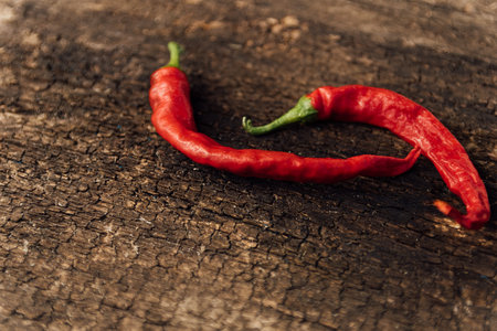 Red hot chili peppers on wooden background. Selective focus. Copy space.